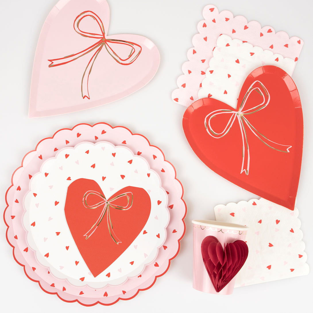 Our party napkins, crafted in the shape of hearts, featuring pink and red colors and fashionable bows.