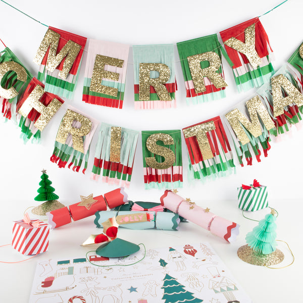 Our Christmas table set includes colorful fun items including crackers, party hats, coloring placemats and a Christmas garland.