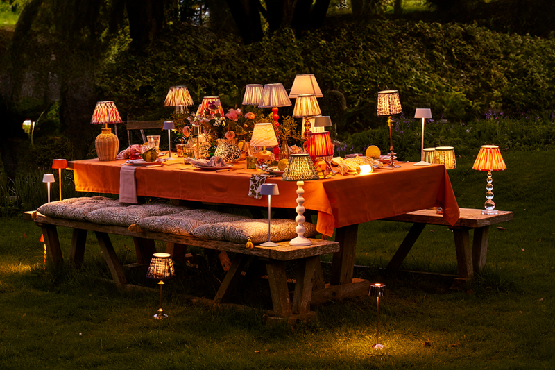 An outdoor table decorated with Pooky lights