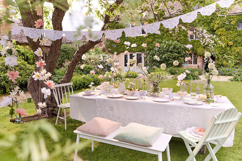 Elegantly set outdoor dining table in a garden