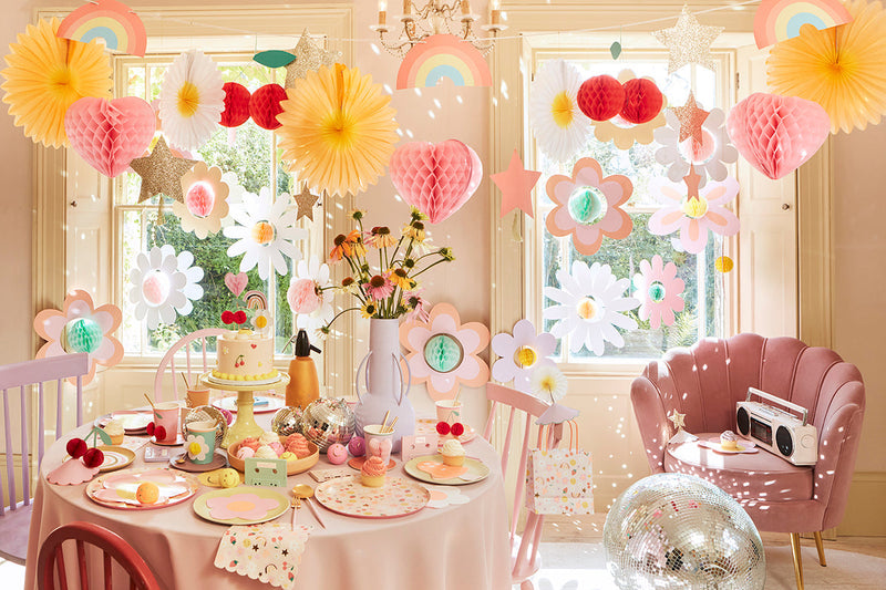 Party setup with pinks, yellows, and floral accents