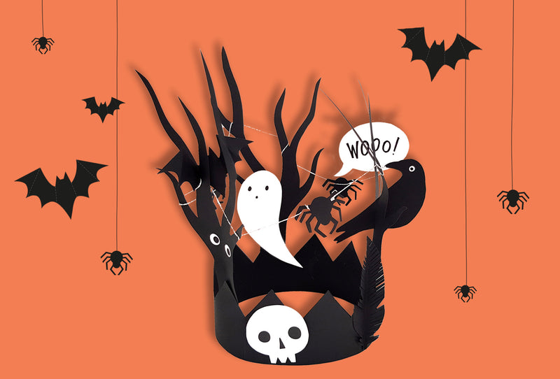 A Halloween headpiece made out of black card features bats, spiders, a ghost, skull and raven as part of the design.