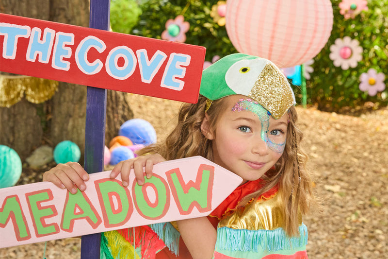 Girl wearing a colourful parrot costume 