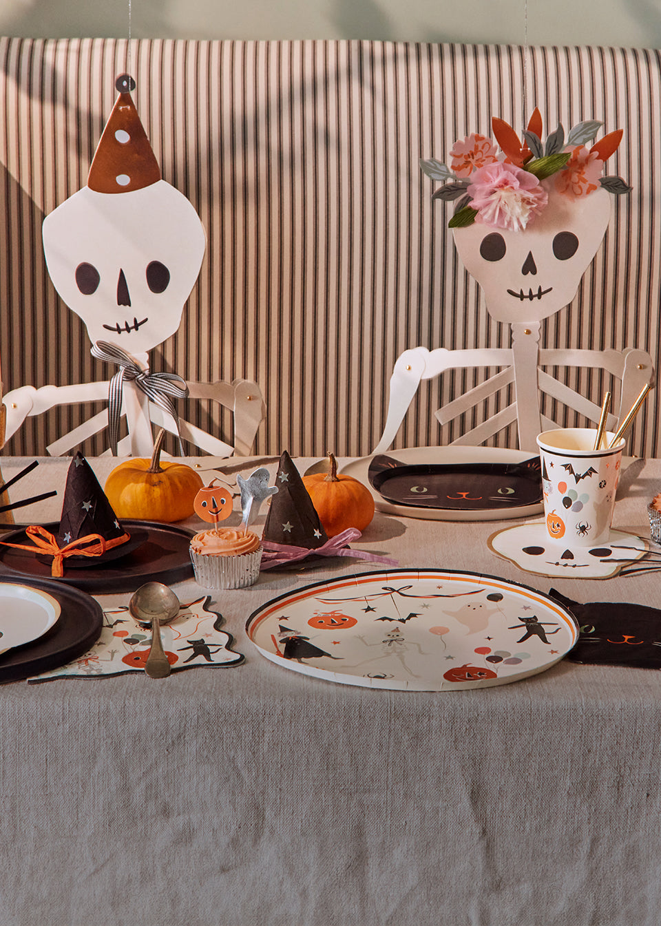 A Halloween party table is decorated with Meri Meri Halloween plates, cups and napkins with vintage-inspired designs. Mobile