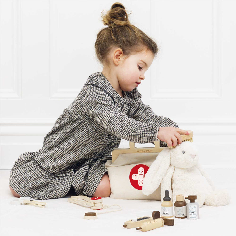 Child playing vet with a stuffed animal