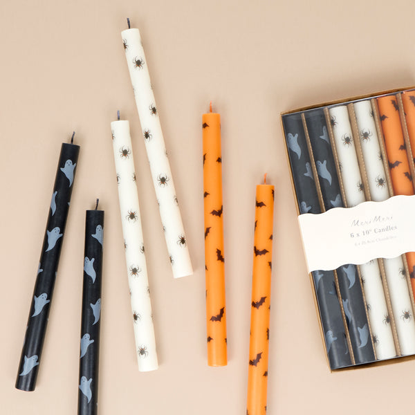 Our tall Halloween candles, in orange, black and white, feature ghosts, bats and spiders, and colored wicks. Ideal for party decorations. Image1