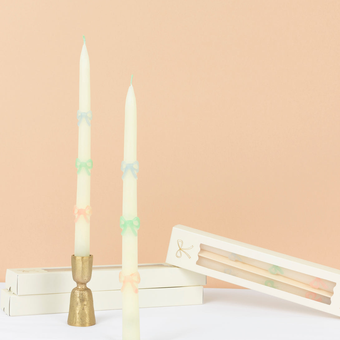 Our party candles, crafted in a tapered shape with embossed and handpainted pastel bows, have mint green wicks. Image1