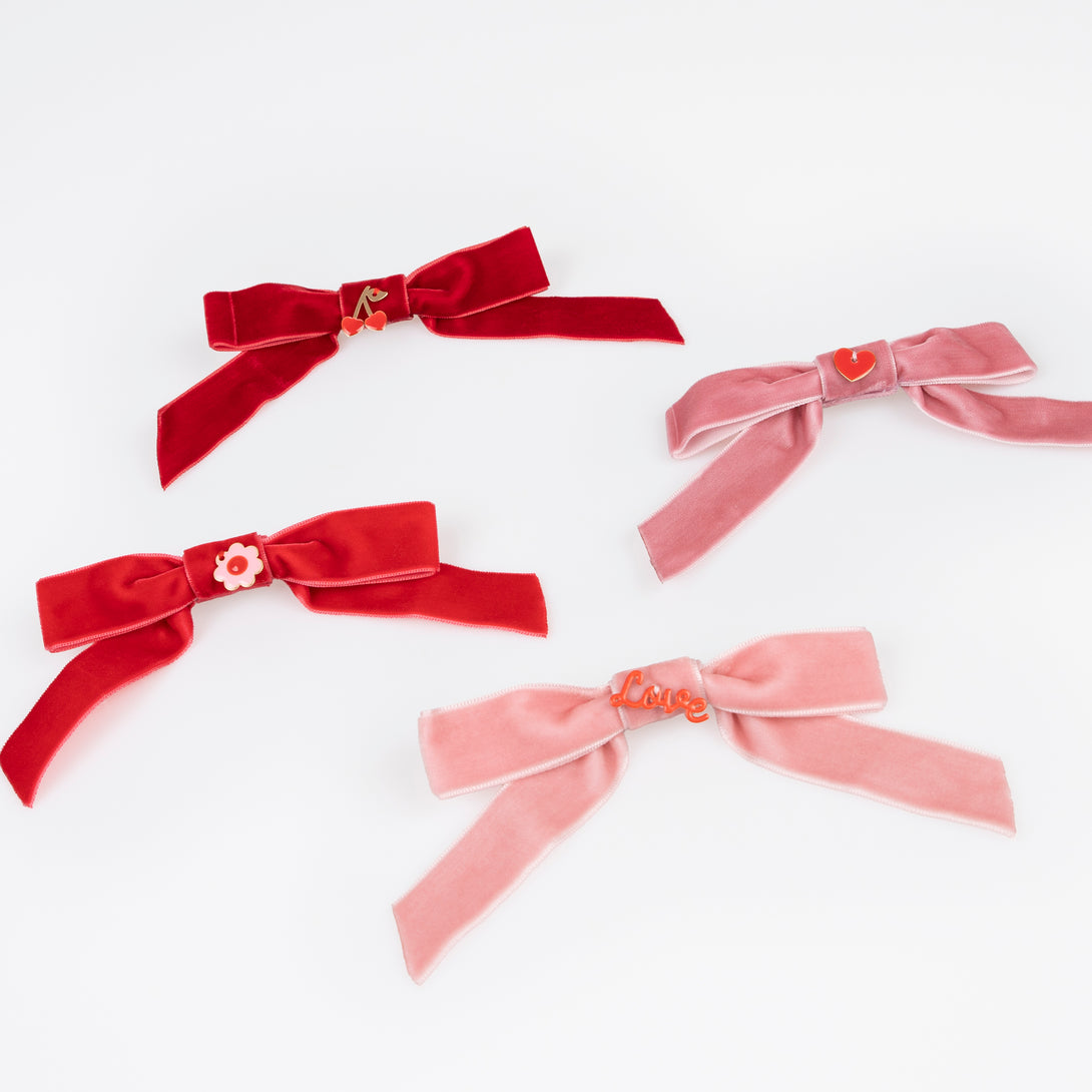 Our Valentine's hair accessories, made with soft velvet bows and enamel charms, make great Valentine's day gifts.