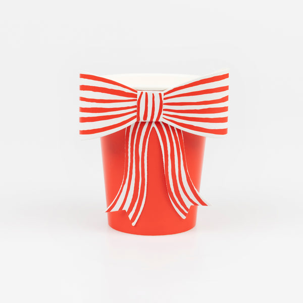 Our disposable red cups feature a festive red and white striped bow, perfect to serve Christmas drinks in. Image1