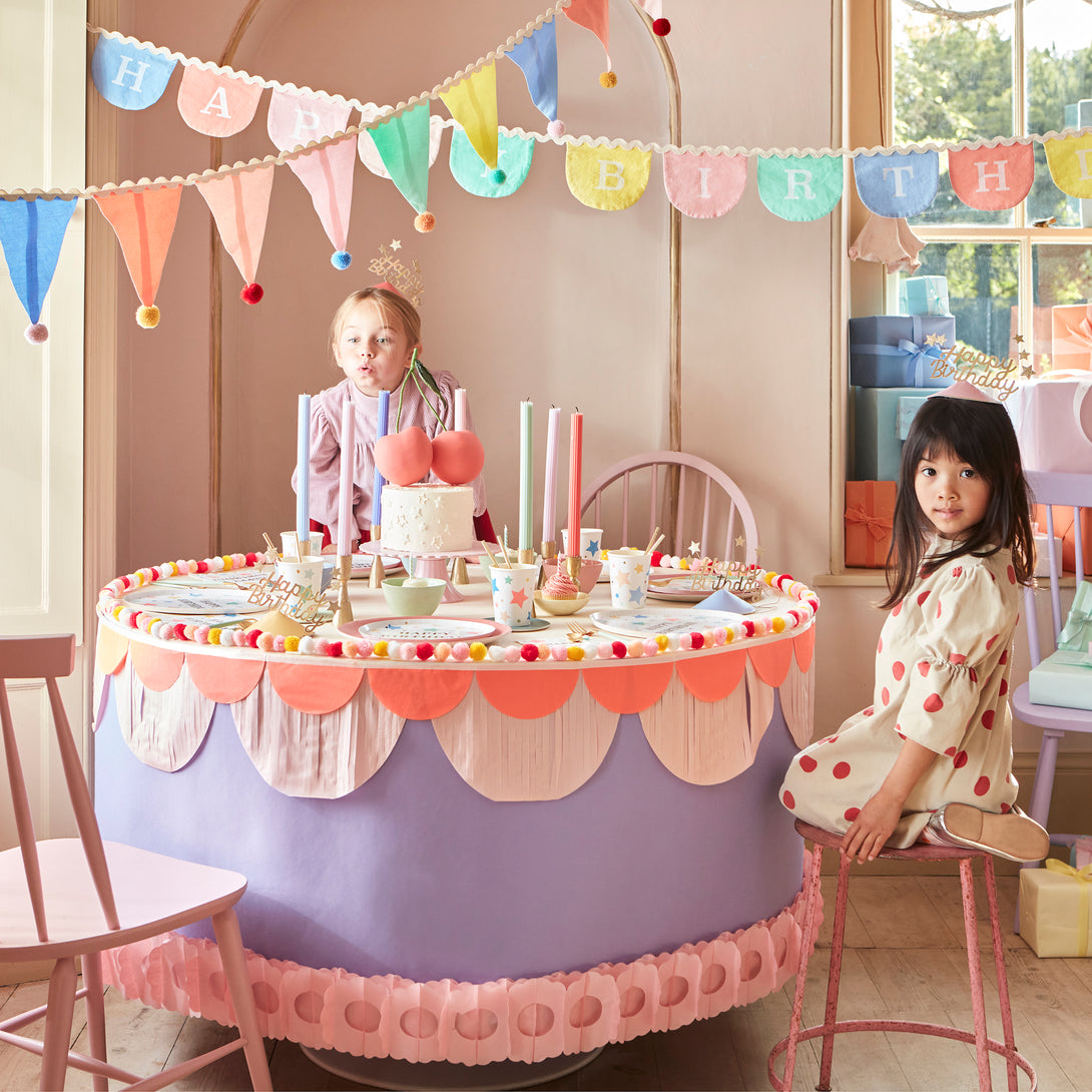 Add a pop of pastel color to your party table or wall with our flag garland with pompoms.