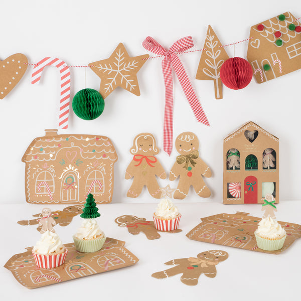 Our special Christmas party supplies include gingerbread house paper plates, party napkins, a cupcake kit and a fabulous festive garland.