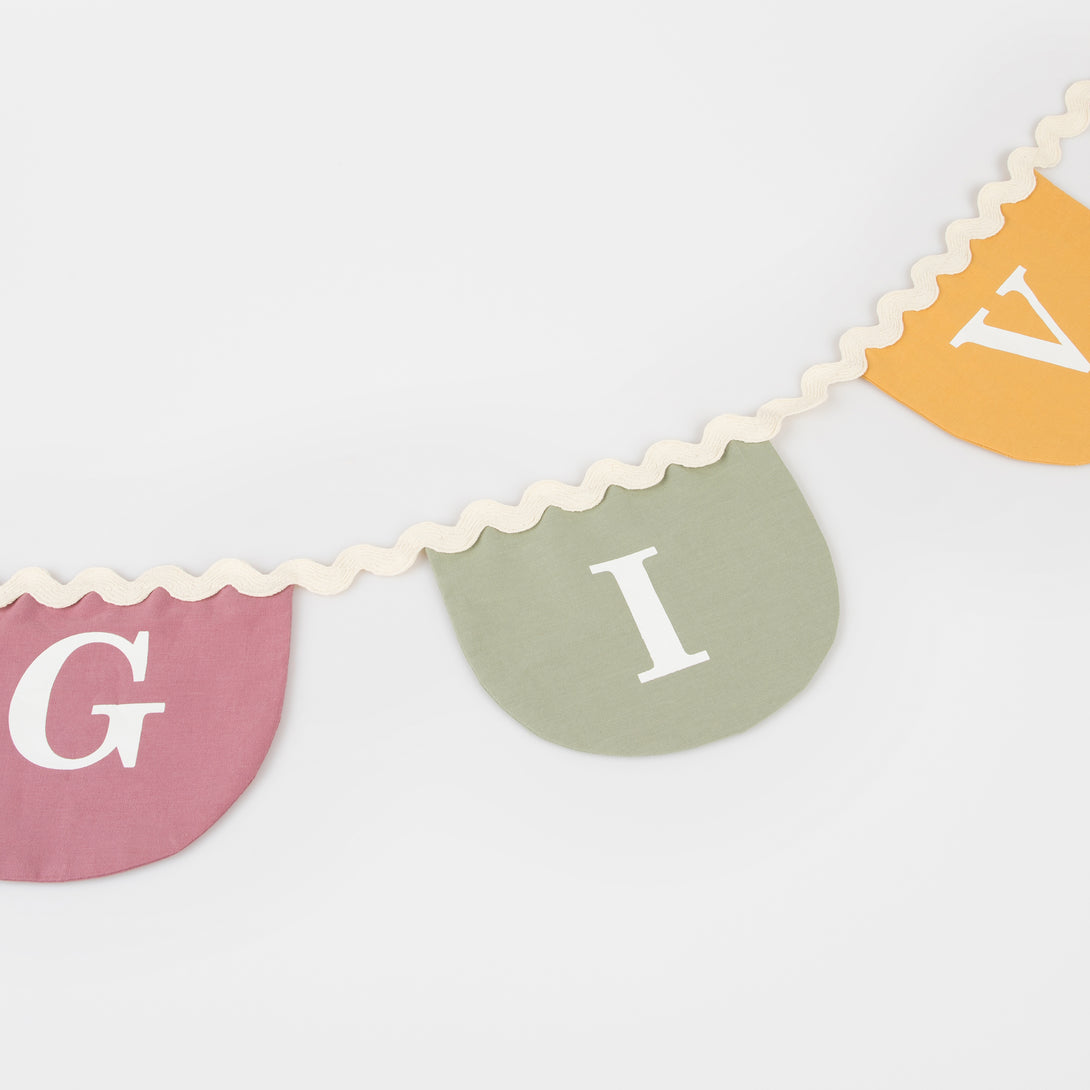 Our Thanksgiving garland, crafted in fabric, is a reusable decoration to add to your Thanksgiving party supplies.