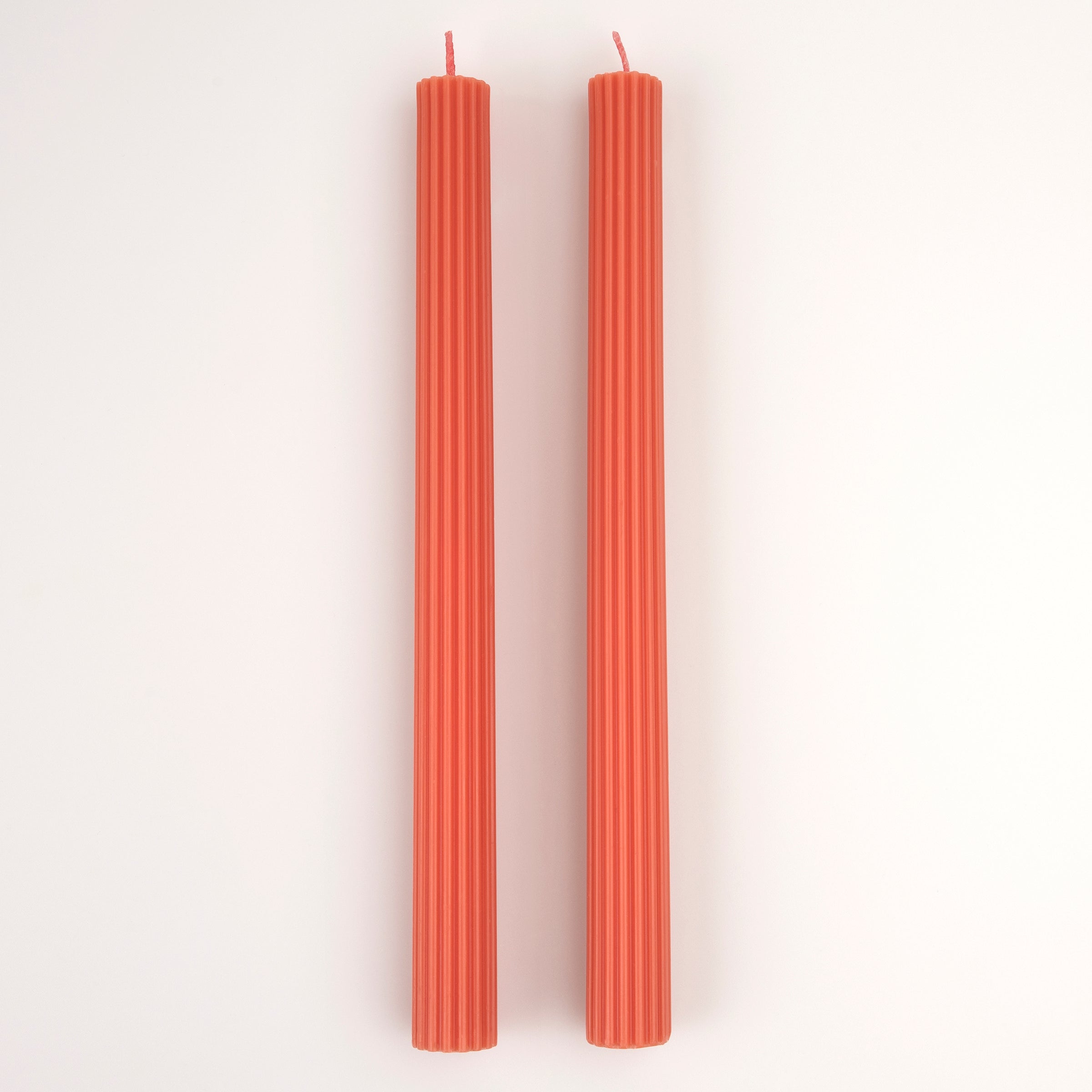 Our tall candles, in coral, are wonderful as a hostess gift or table decoration.