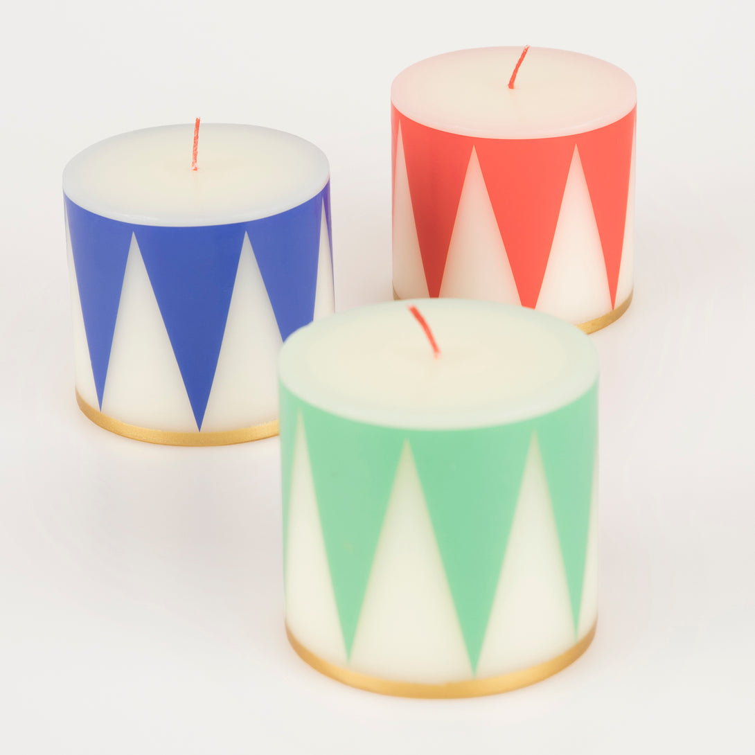 Our Christmas candle set of 3 candles have traditional Nutcracker designs of red, green and blue, with gold details and red wicks.