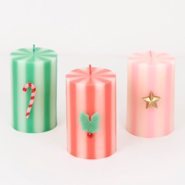 Our Christmas candles, in a stylish pillar shape, feature, green, red, white and pink stripes, with wax icons and elegant colored wicks. A great gift. Image1