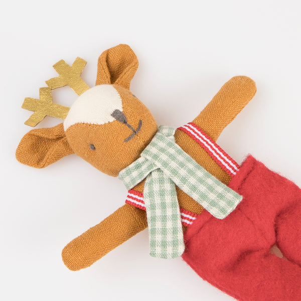 Our Christmas doll set includes a mini fabric reindeer doll in a laminated mini suitcase designed to look like a gingerbread house. Image3
