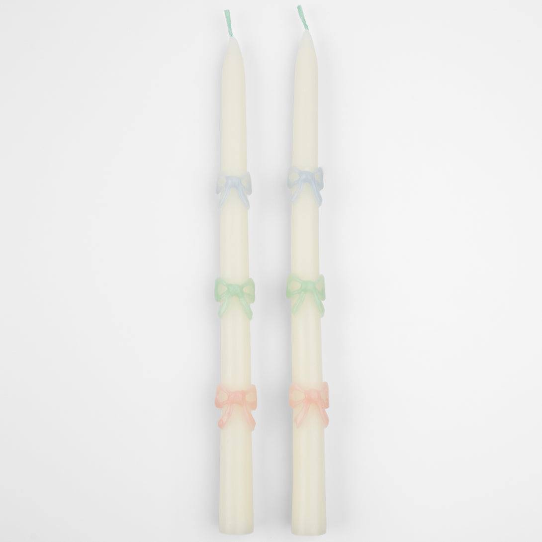 Our party candles, crafted in a tapered shape with embossed and handpainted pastel bows, have mint green wicks.