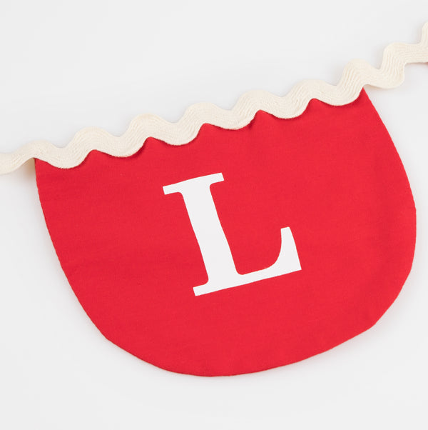 Our Valentine's decoration, a fabric garland, has scalloped pennants in red and pink with a romantic message. Image3