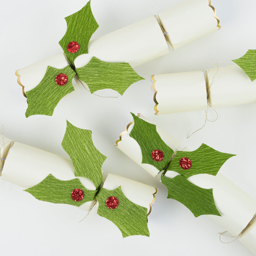 Our crackers are beautifully embellished with holly and berries, and contain Christmas brooches and gold party hats.