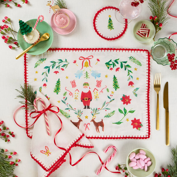 Our Christmas placemats, made from a linen and cotton mix, feature Santa in a folk-inspired scene, with gold embroidery and a crochet trim. Image2