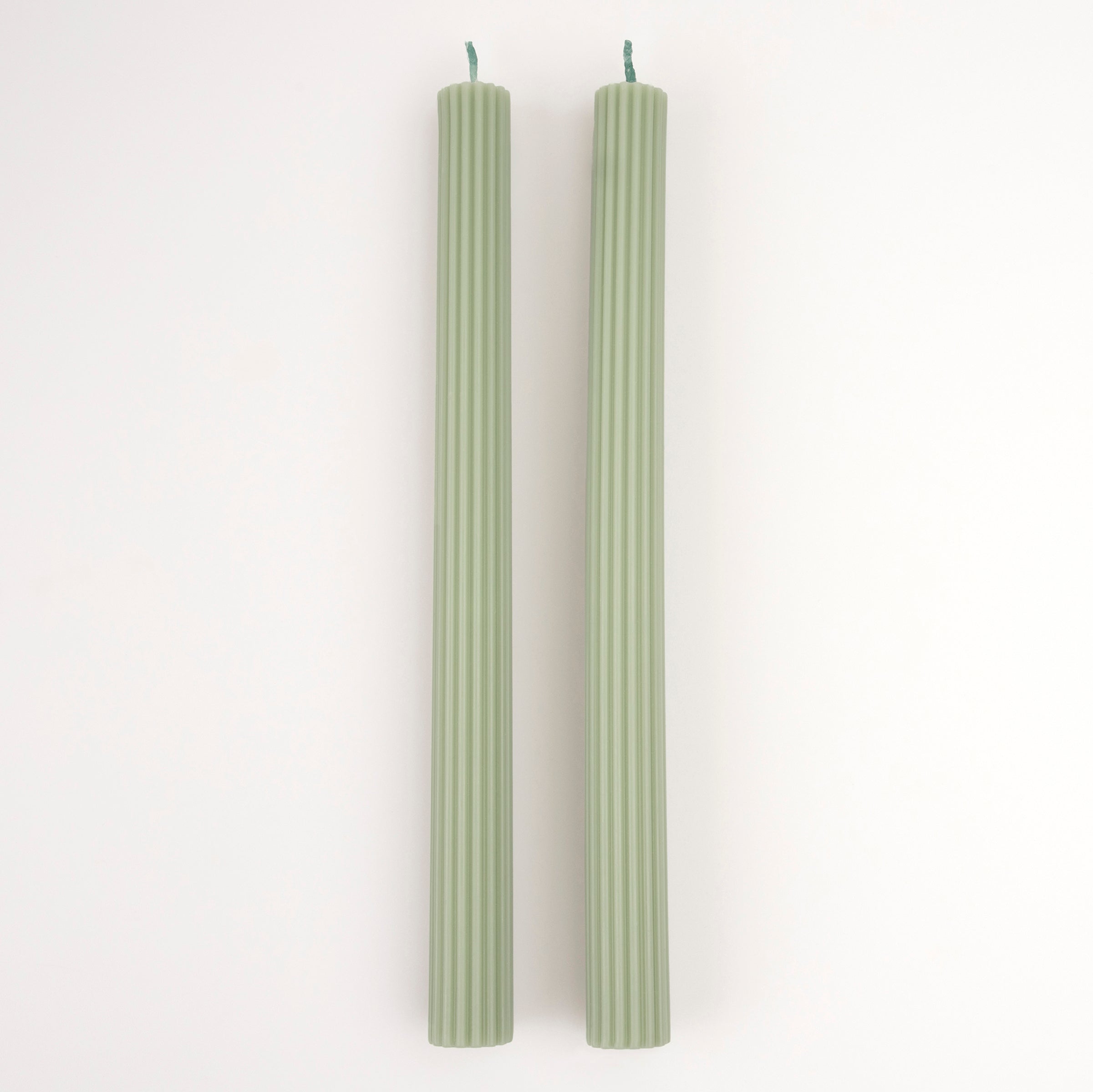 Our table candles, long with ridged details, are in a gorgeous green shade.