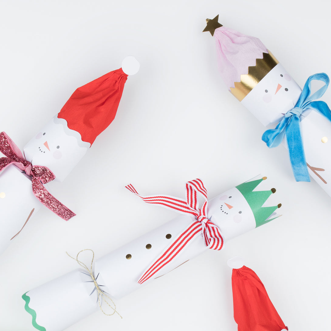 Our family crackers feature jolly snowmen with scarves and hat embellishments, and contain a joke, party hat and a fun eraser.