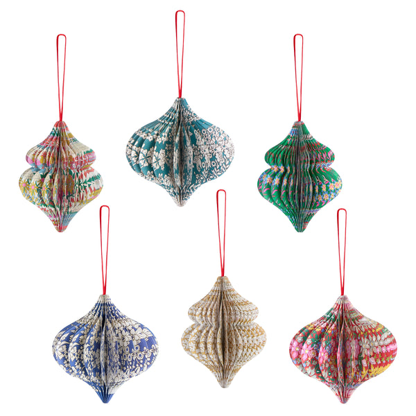 Our Christmas tree decorations, in elegant ornamental shapes, have honeycomb details and beautiful Liberty print designs in festive colors. Image1