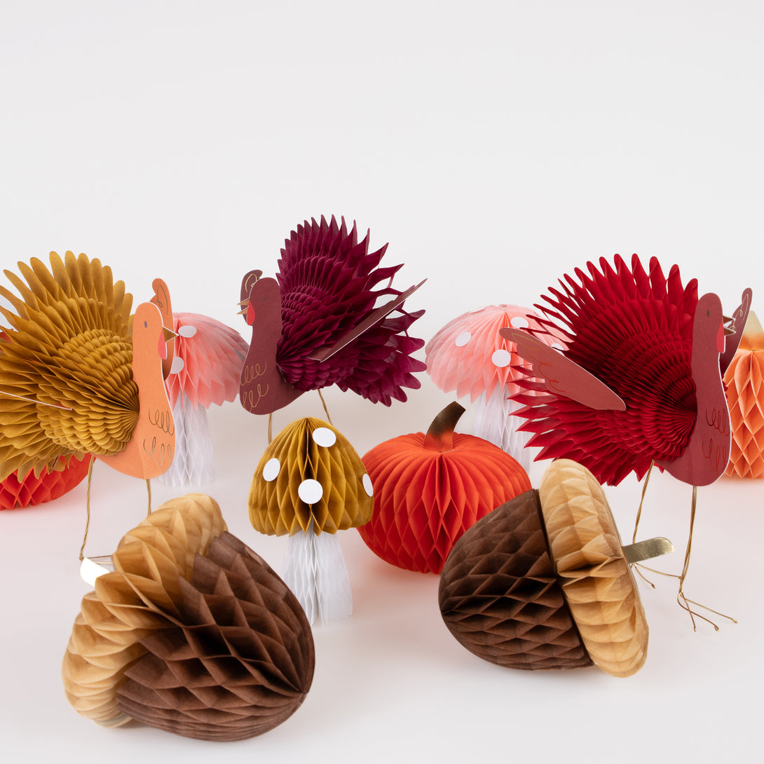 Our Thanksgiving table decorations include honeycomb turkeys, pumpkins, mushrooms and acorns.