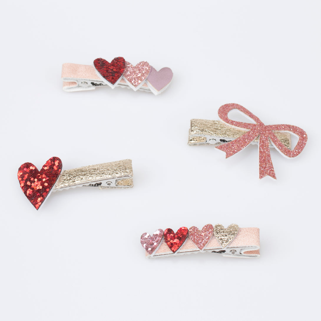 Our glitter hair clips, with pink and red glitter fabric, hearts, bows and a rainbow, are perfect as Valentine's gifts.