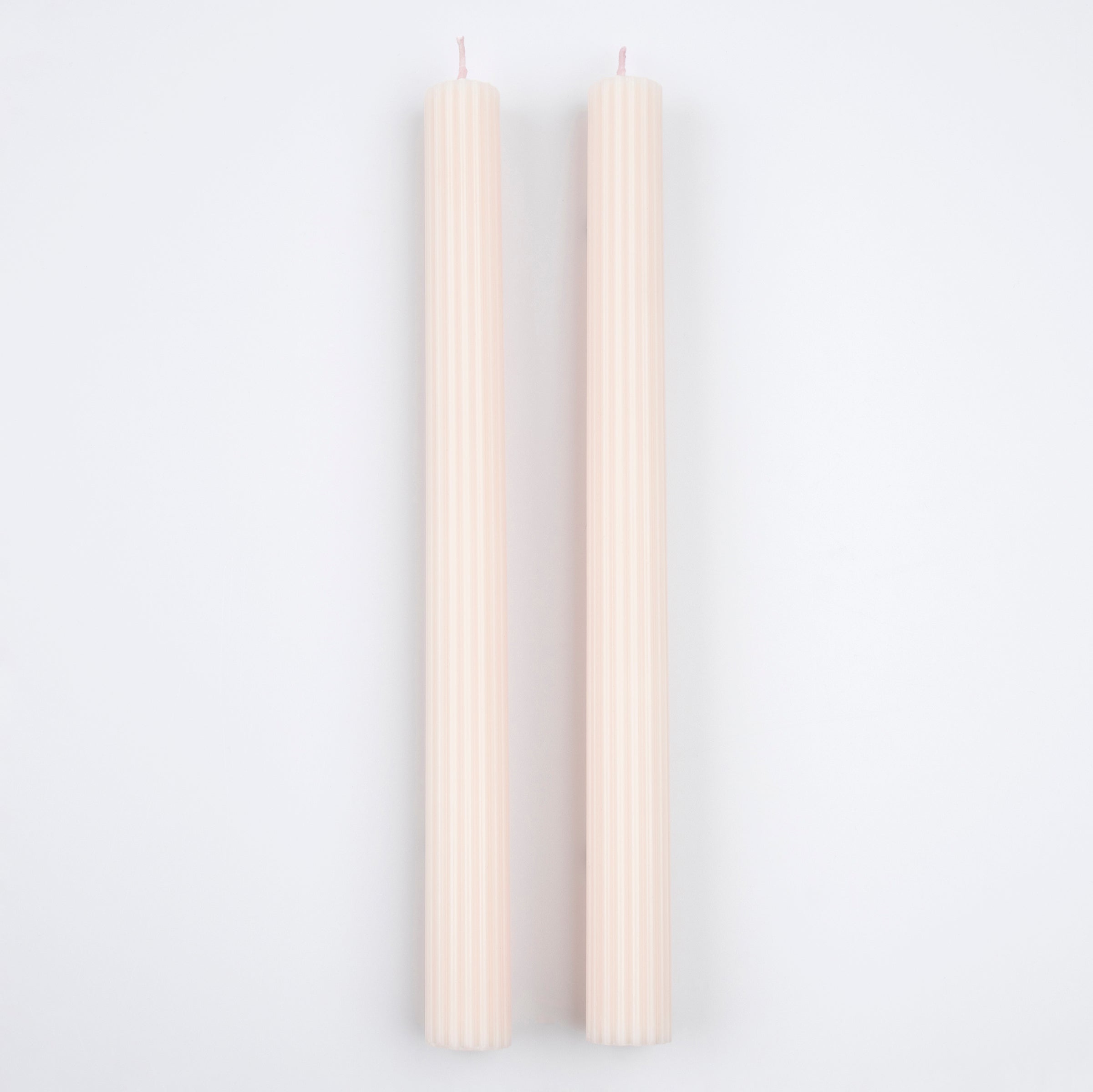 Decorate your table or mantel with our ridged long candles in a pretty peach pink shade.