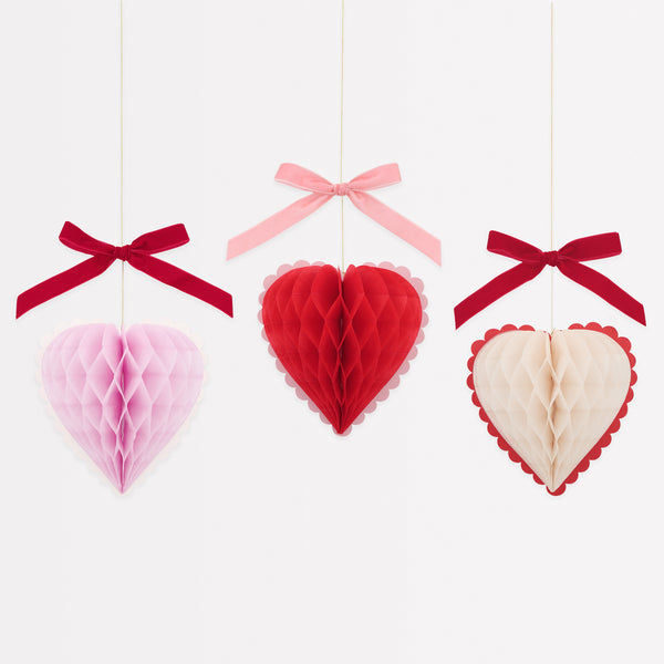 Our Valentine's hanging decorations, 3D honeycomb hearts in pink, red and cream with velvet ribbons, are perfect to set the scene for love