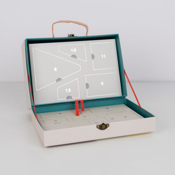 This kids advent calendar is presented in a mini suitcase which contains wooden trains. Image4