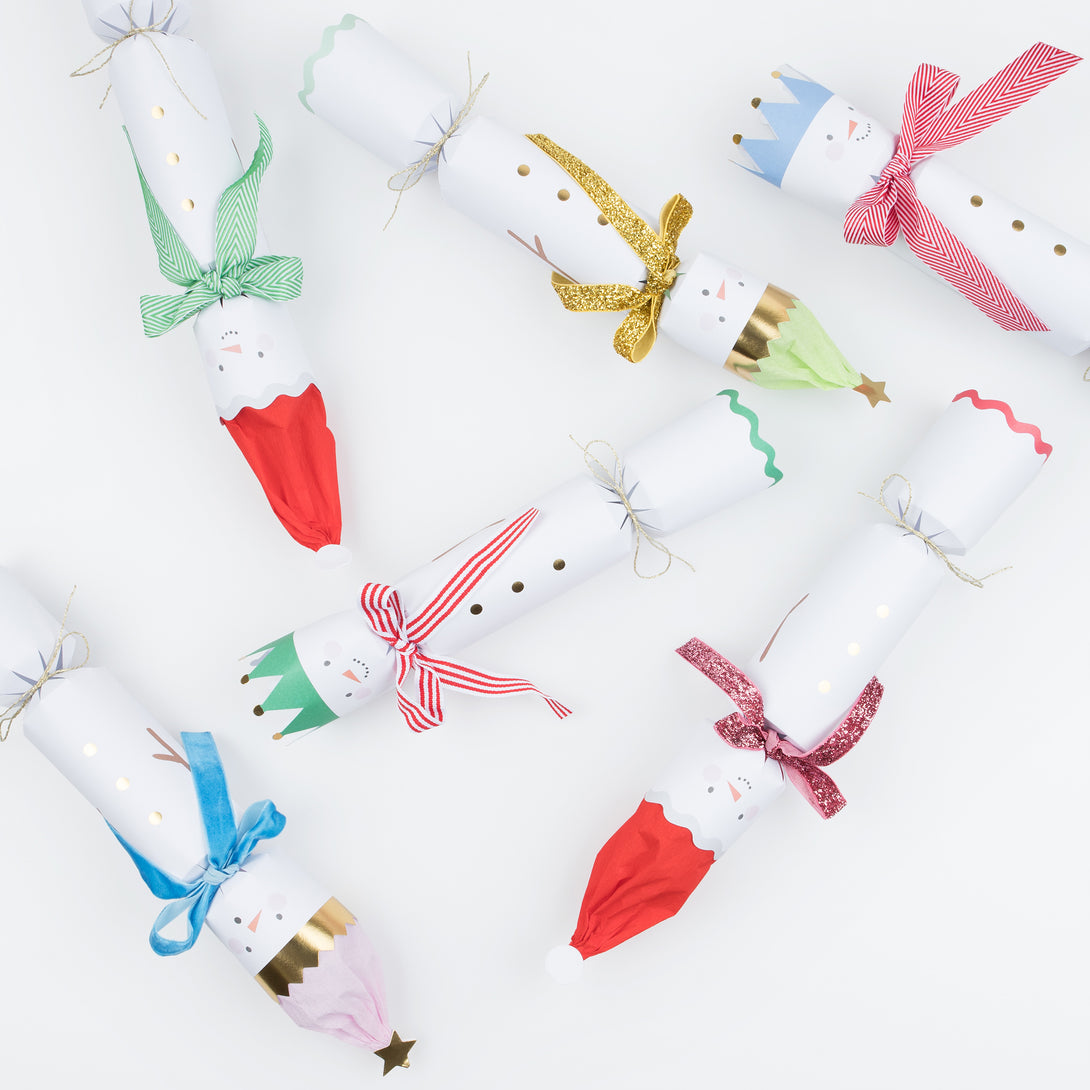 Our family crackers feature jolly snowmen with scarves and hat embellishments, and contain a joke, party hat and a fun eraser.