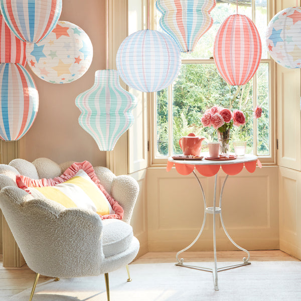 Decorate a room with our striped lanterns, crafted from paper with a pink cord for hanging. Image2