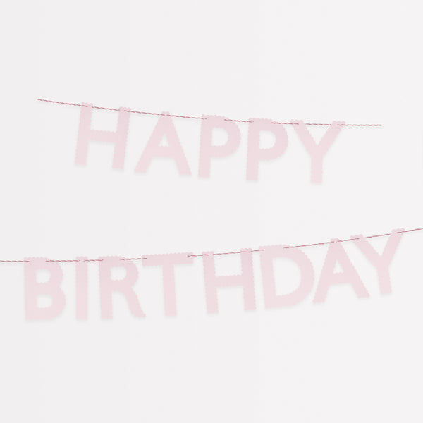 Our pink garland, made with scalloped pink paper, is a pretty decoration for a birthday party.