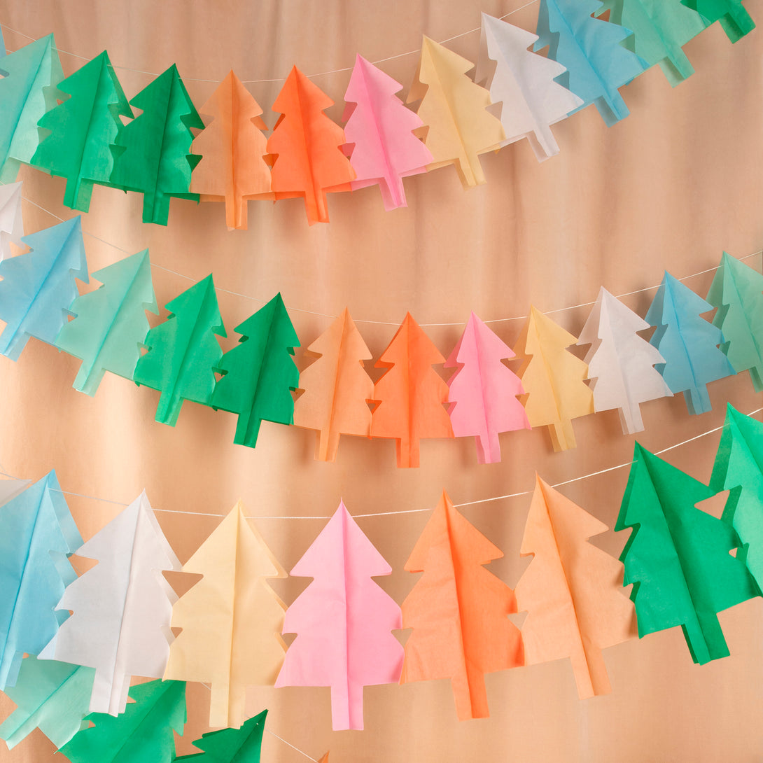 Our hanging Christmas decorations feature tissue paper Christmas trees in lots of colors for a merry and bright look.