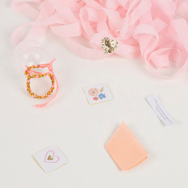 These are crafted with pink tones of crepe paper, and feature friendship bracelets, paper party hats and foil stickers. Image3
