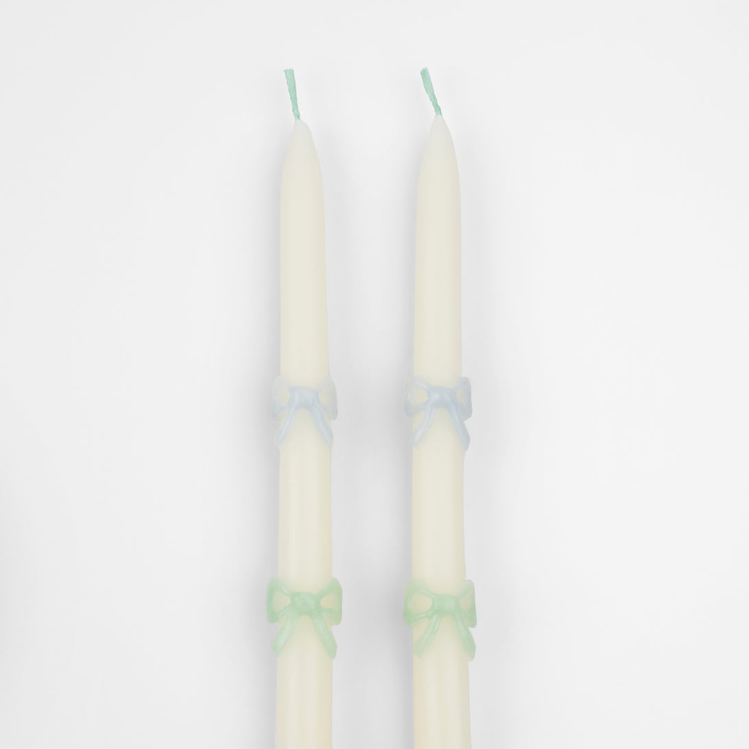 Our party candles, crafted in a tapered shape with embossed and handpainted pastel bows, have mint green wicks.