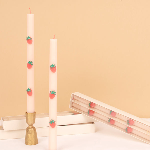 Our table candles, in a soft pink shade with wax strawberries and red wicks, are ideal as a host gift or a candle gift.