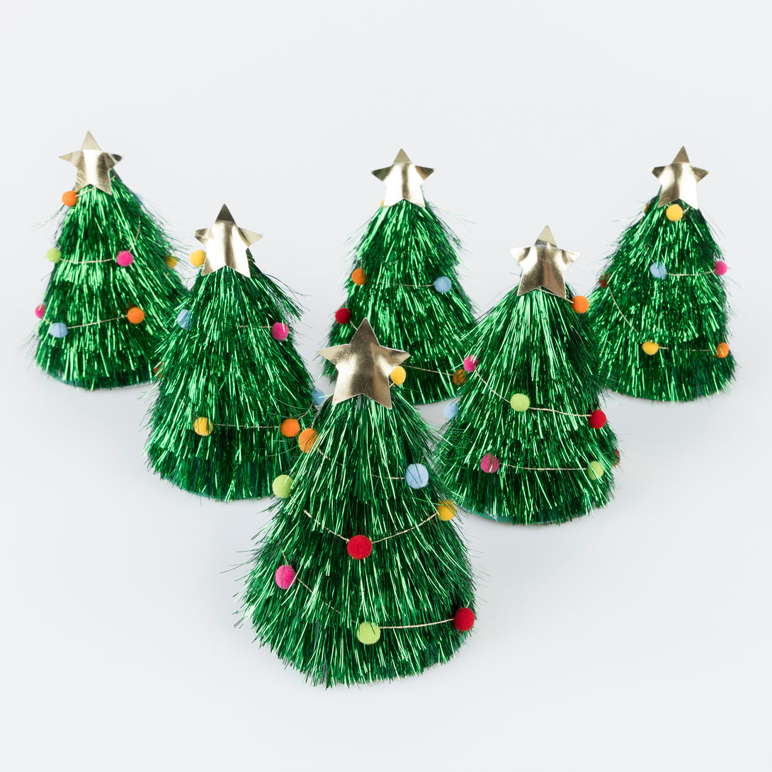 Wear our Christmas paper hats, in the shape of pompom-adorned Christmas trees with tinsel and gold stars, for lots of family fun. Image2