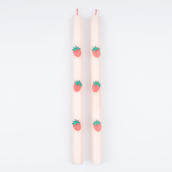 Our table candles, in a soft pink shade with wax strawberries and red wicks, are ideal as a host gift or a candle gift. Image3