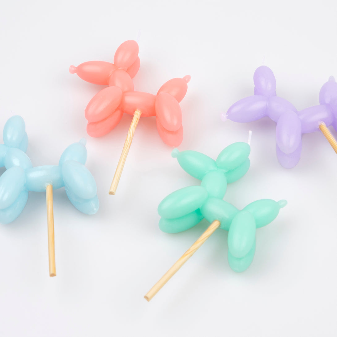 Make your birthday cake decorations look amazing with our fun candles crafted in the shapes of colorful balloon dogs.