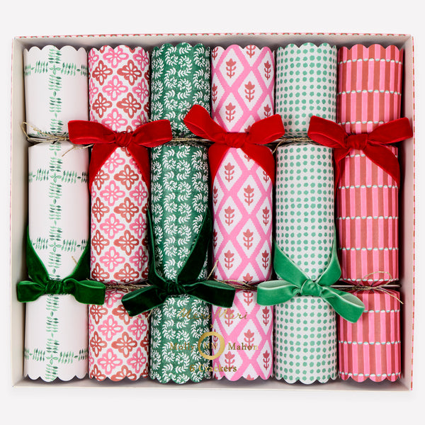 Our luxury Christmas crackers feature Molly Mahon block print designs in seasonal colors and velvet bows, with a hat, joke and special gift inside. Image1