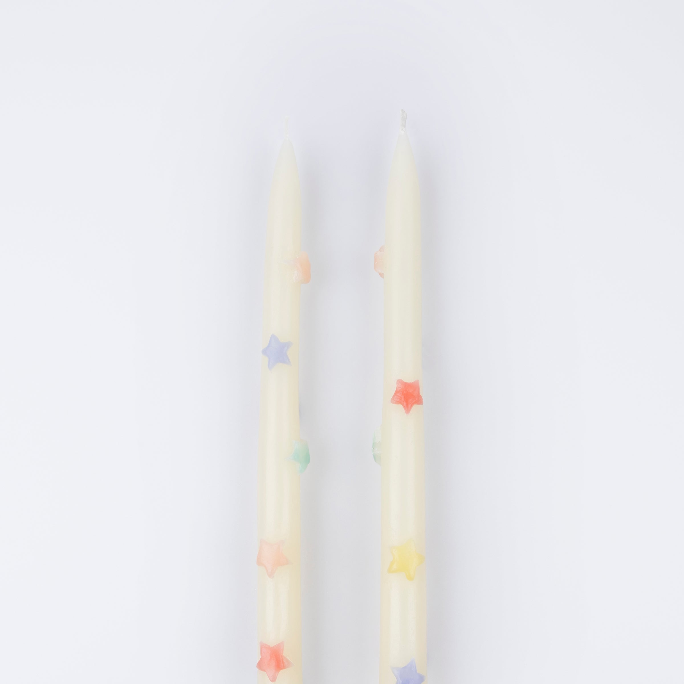 Our taper candles, with colored stars, will look great as table candles or on placed on the mantel.