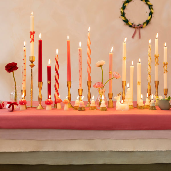 Use our Christmas table candles, with festive patterns and colors, to light up your dinner table or mantel. Image2