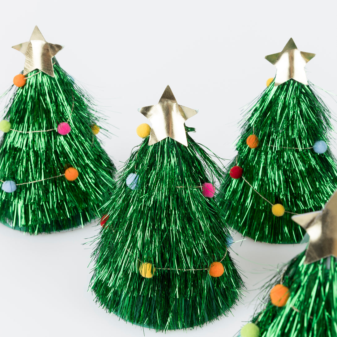 Wear our Christmas paper hats, in the shape of pompom-adorned Christmas trees with tinsel and gold stars, for lots of family fun. Image3