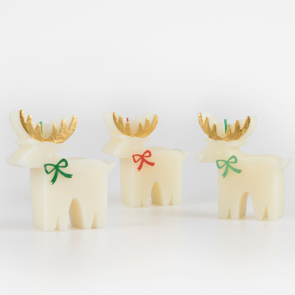 These Christmas table candles are reindeers with on-trend bows, gold details and fabulous colored wicks, a great host gift. Image2