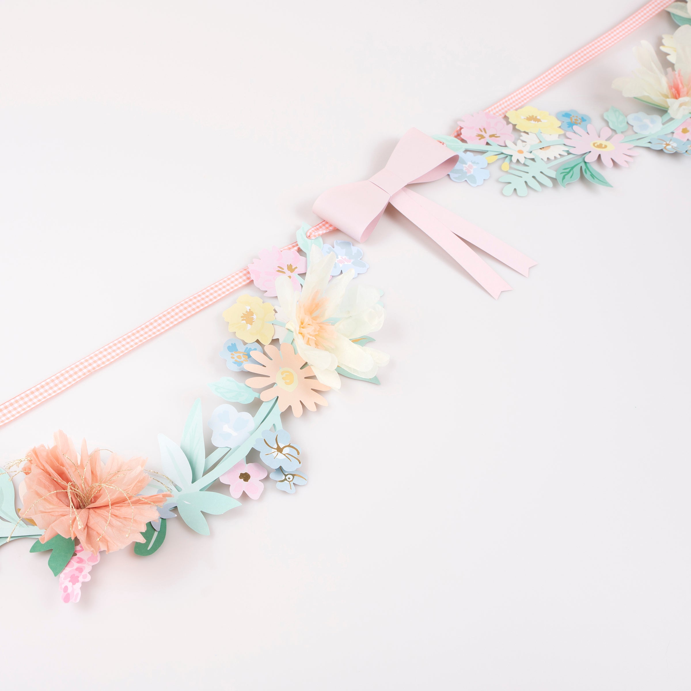 Our paper garland, featuring flowers and bows, is the perfect baby shower garland or Easter garland.
