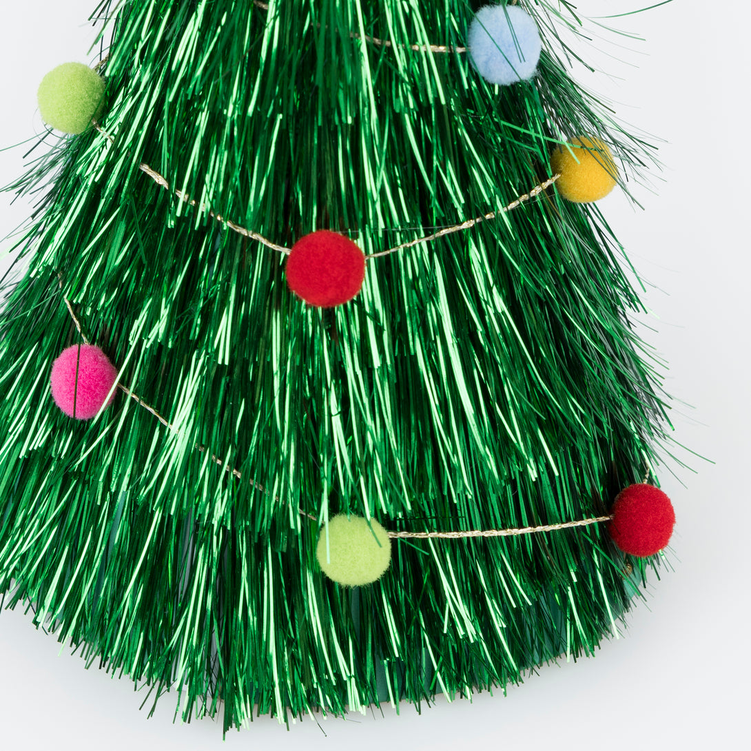 Wear our Christmas paper hats, in the shape of pompom-adorned Christmas trees with tinsel and gold stars, for lots of family fun. Image4
