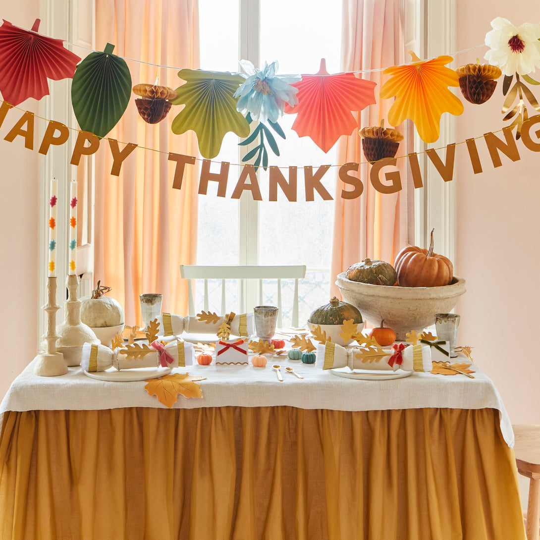 Our Thanksgiving garland has the perfect mix of fall leaves, paper flowers and the words Happy Thanksgiving.